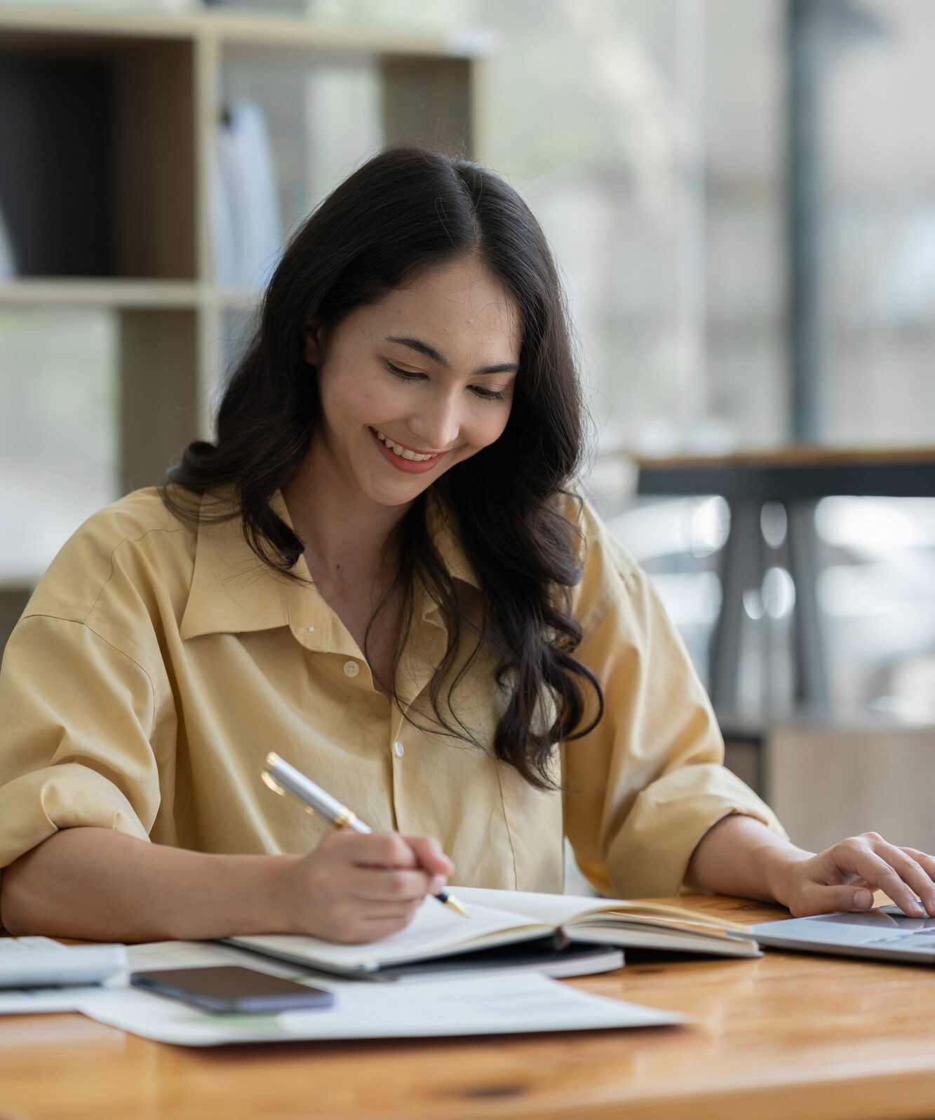 Confident Asian businesswoman using laptop calculator Paperwork for financial work, calculations on